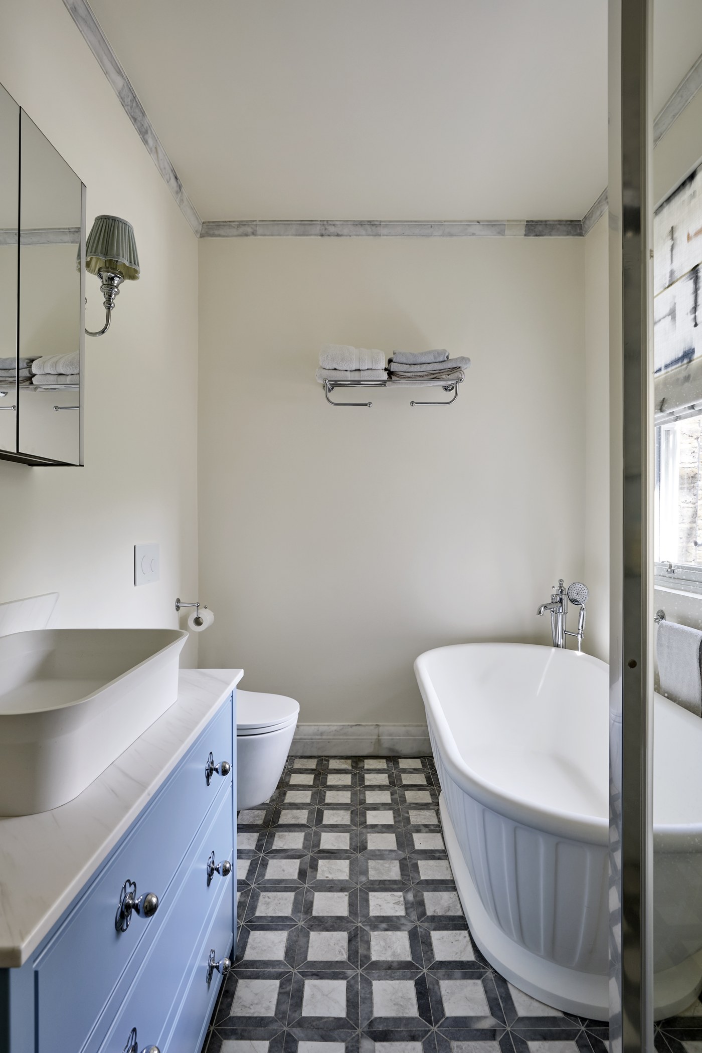 Bathroom at Achilles Road with a freestanding bath and chequerboard tiled floor