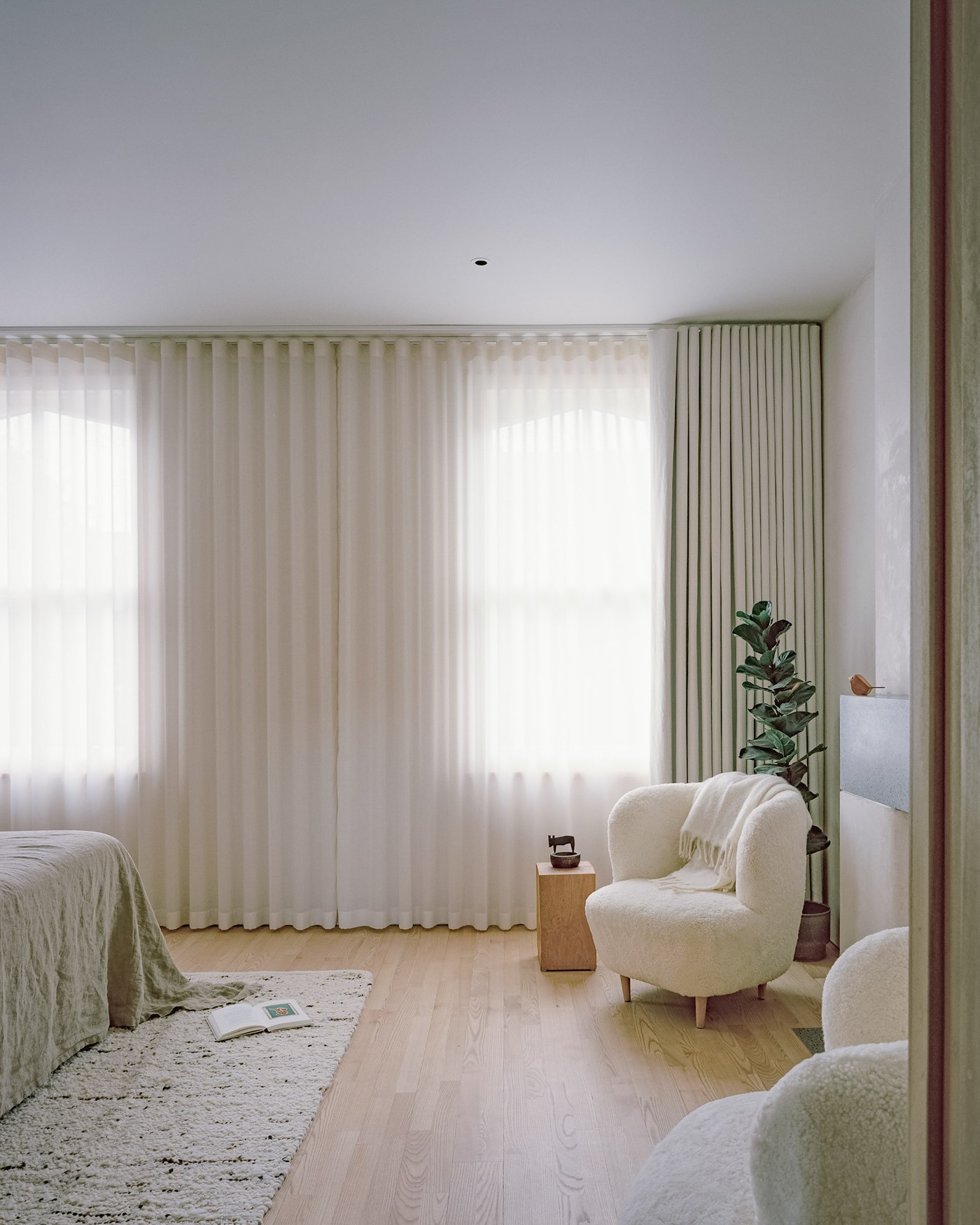 Caithness Road W14 — bedroom with a pair of timber sash windows, full-height curtains and pale timber floor