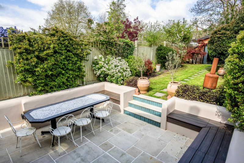 Landscaped rear terrace with built-in seating at Chevening Road