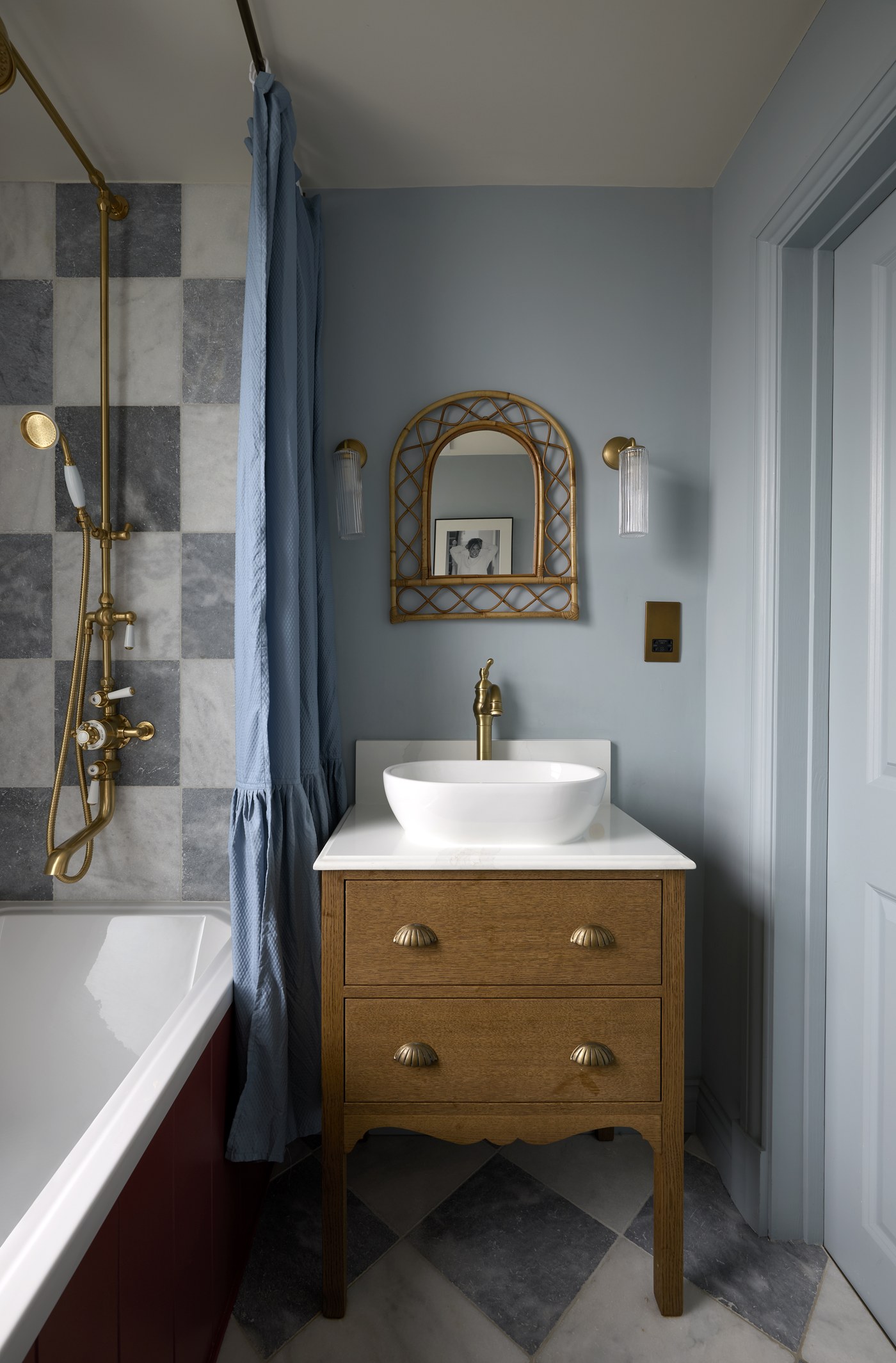Bathroom at Melrose Gardens with a timber vanity, brass fittings and chequerboard tiling