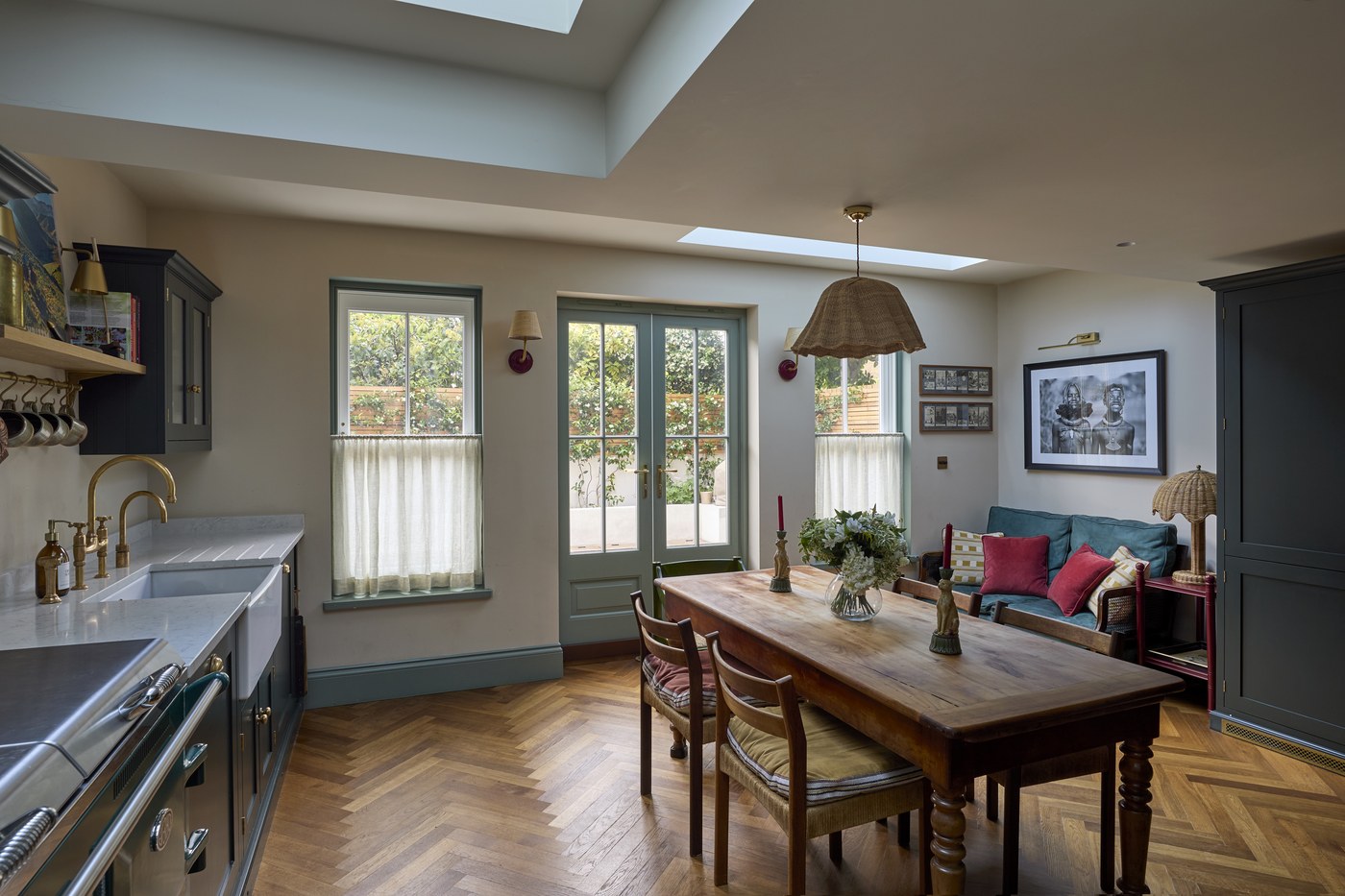 Dining area within the rear extension at Melrose Gardens, lit by a long rooflight and opening to the garden