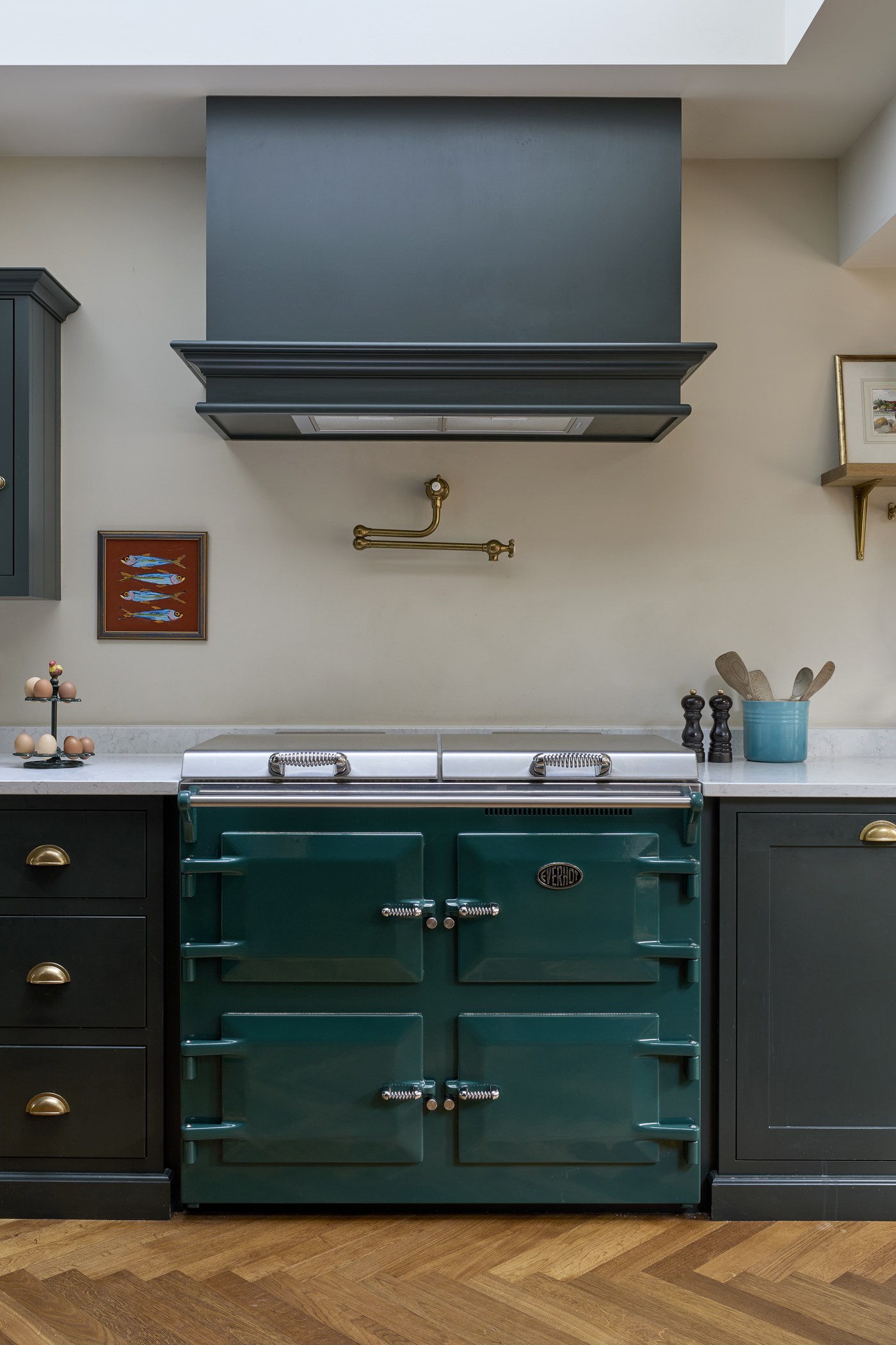 Range and painted kitchen joinery at Melrose Gardens, with a brass pot filler above the range