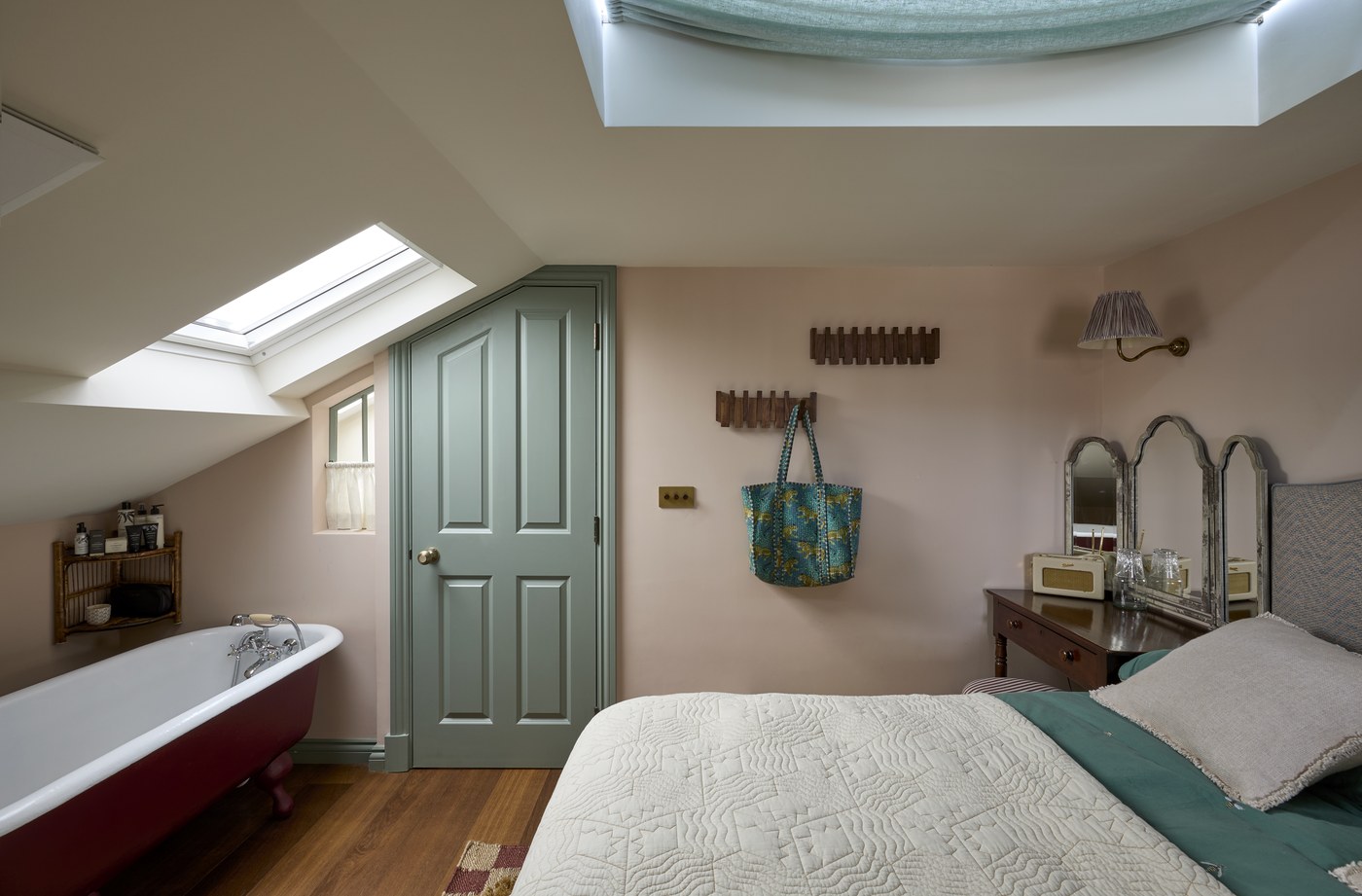 Loft conversion bedroom at Melrose Gardens with fitted cupboards under the slope