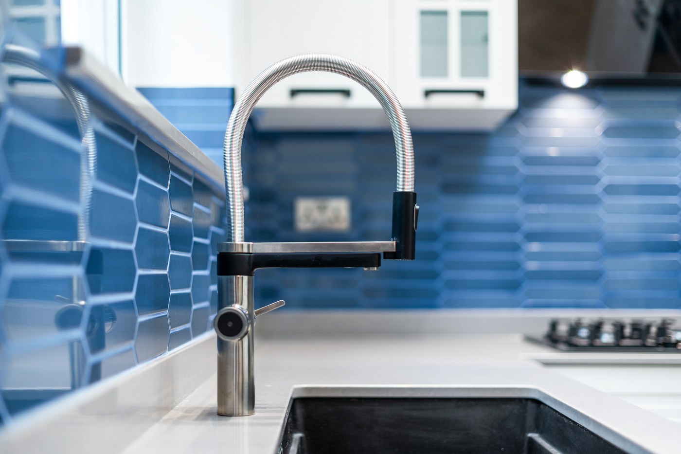 Kitchen tap and blue tiled splashback detail at Millway