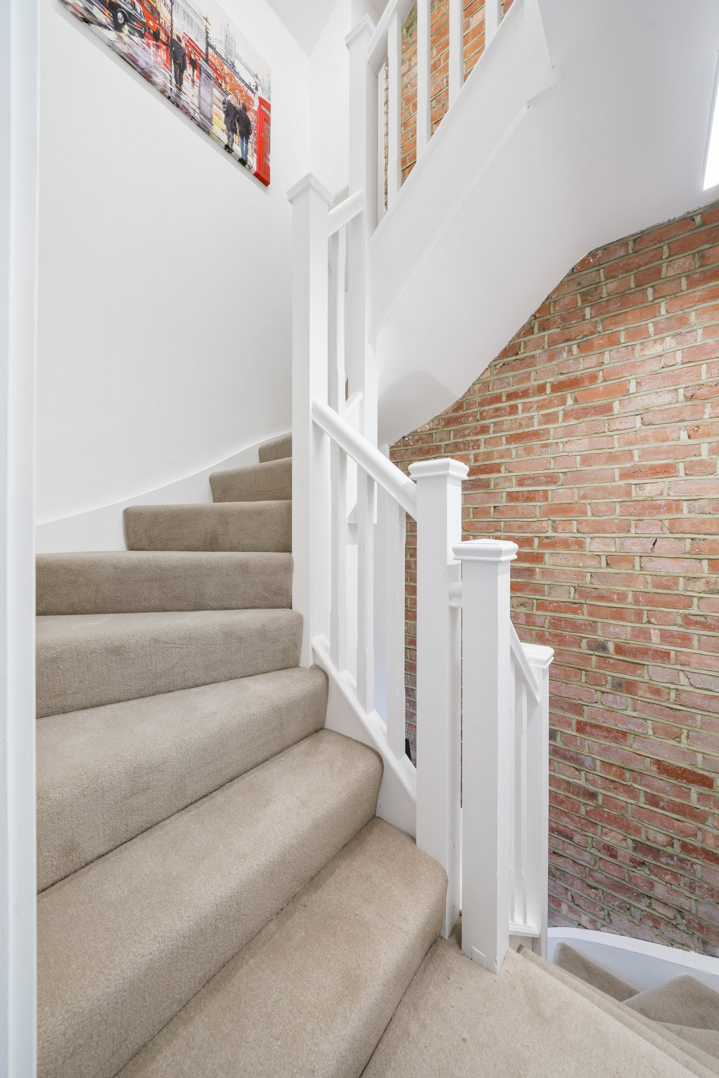 Staircase at Millway alongside retained exposed brickwork